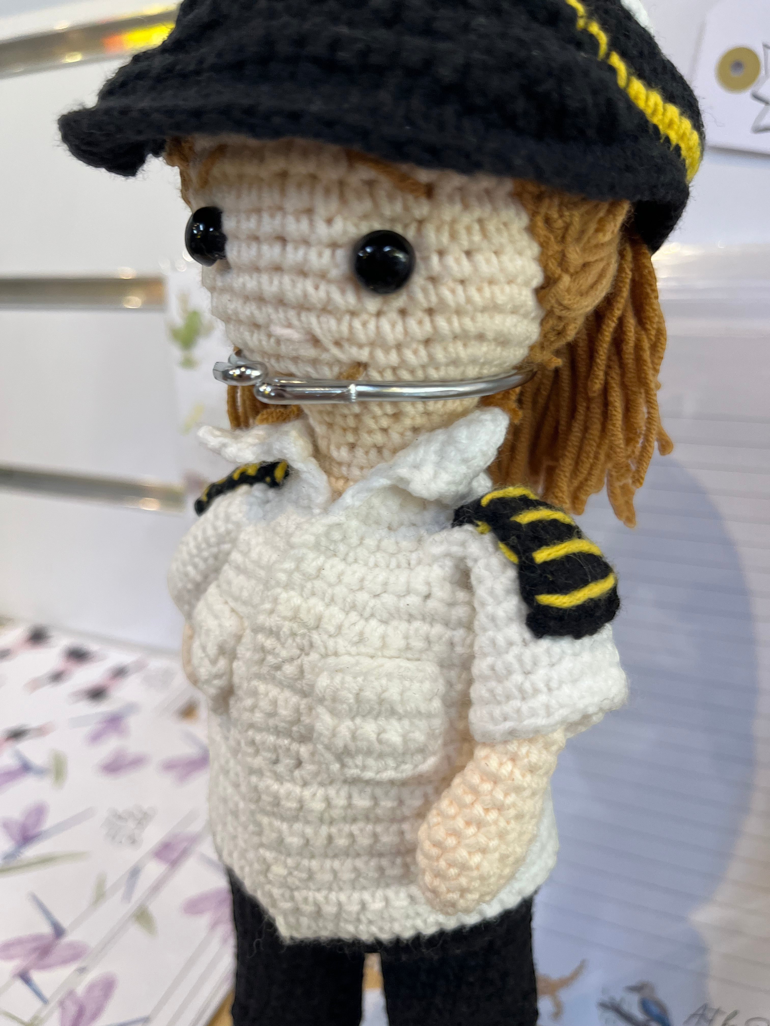 Suzie's Sunshine Dolls handmade crocheted pilot doll in uniform with black hat and yellow trim.