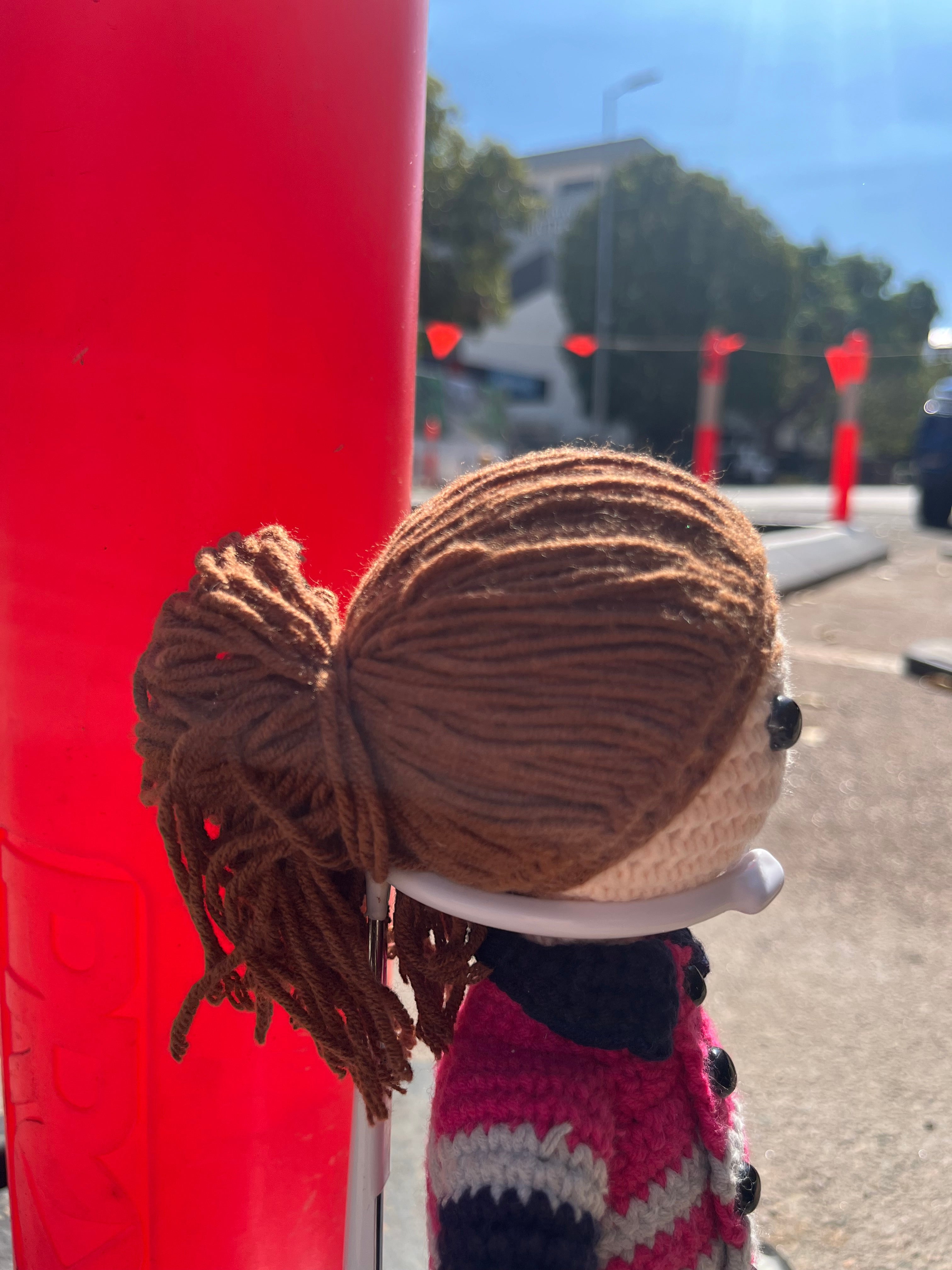 Suzie's Sunshine Dolls Miner/Tradie doll in pink hi-vis crocheted outfit with navy pants and reflective stripes.