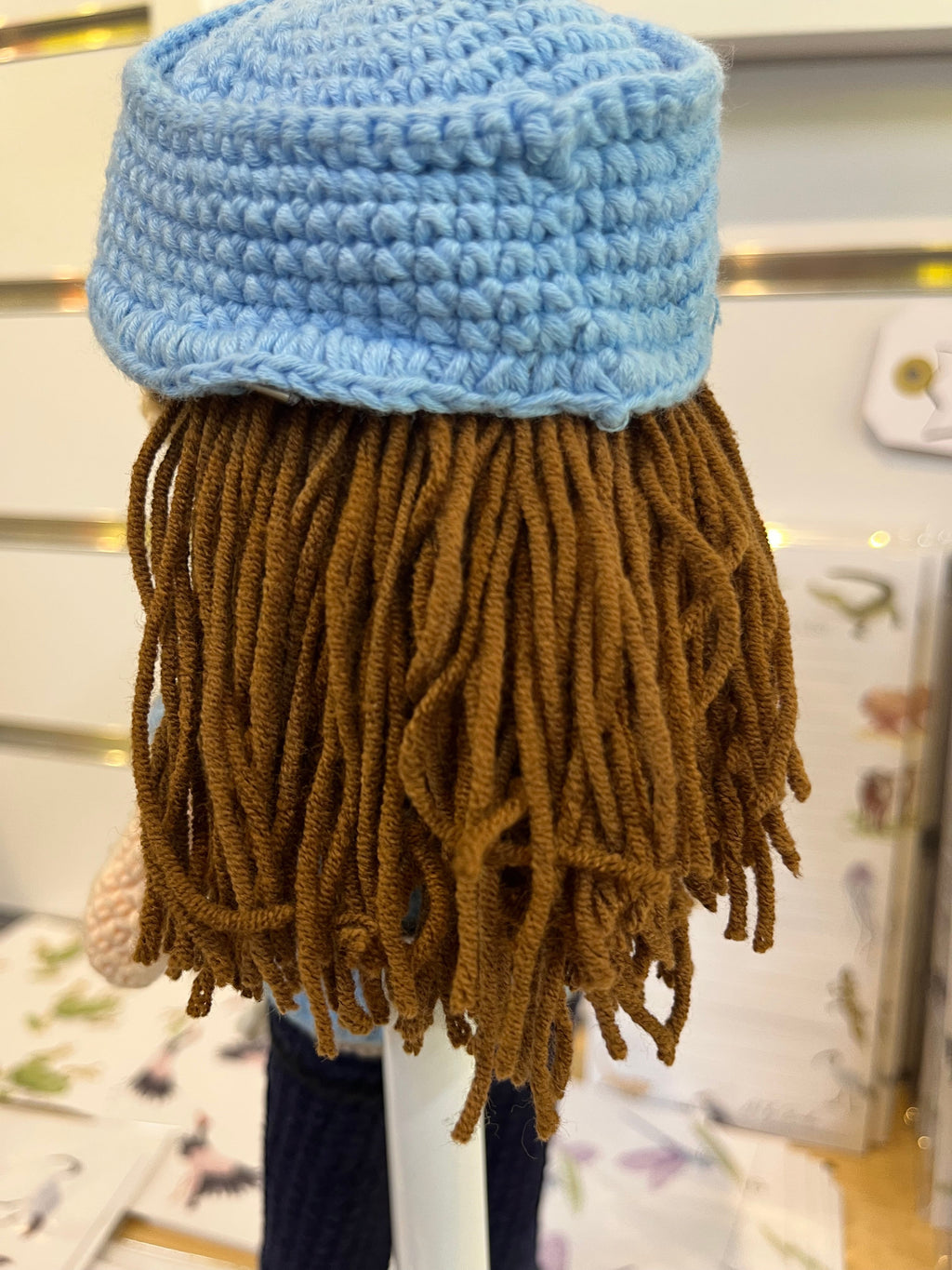 Suzie's Sunshine Dolls Policeman doll with brown yarn hair, blue crocheted cap, and blue uniform. Handcrafted.