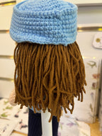Suzie's Sunshine Dolls Policeman doll with brown yarn hair, blue crocheted cap, and blue uniform. Handcrafted.