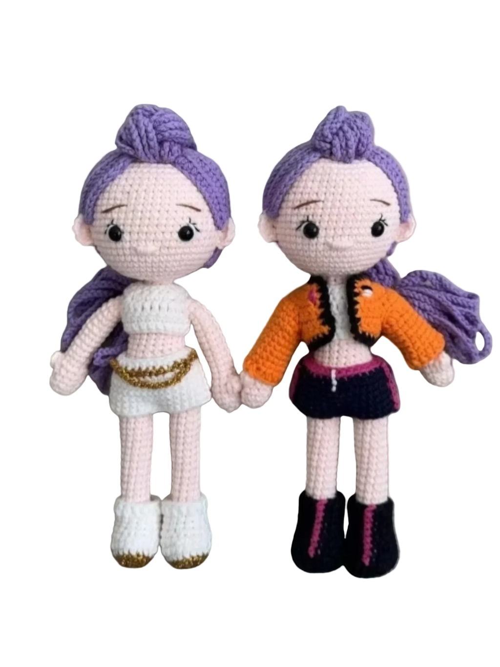 Suzie's Sunshine Dolls Rumi K-Pop Demon Hunter amigurumi doll with purple hair, one in white outfit, one in orange jacket and dark skirt.