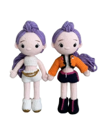 Suzie's Sunshine Dolls Rumi K-Pop Demon Hunter amigurumi doll with purple hair, one in white outfit, one in orange jacket and dark skirt.