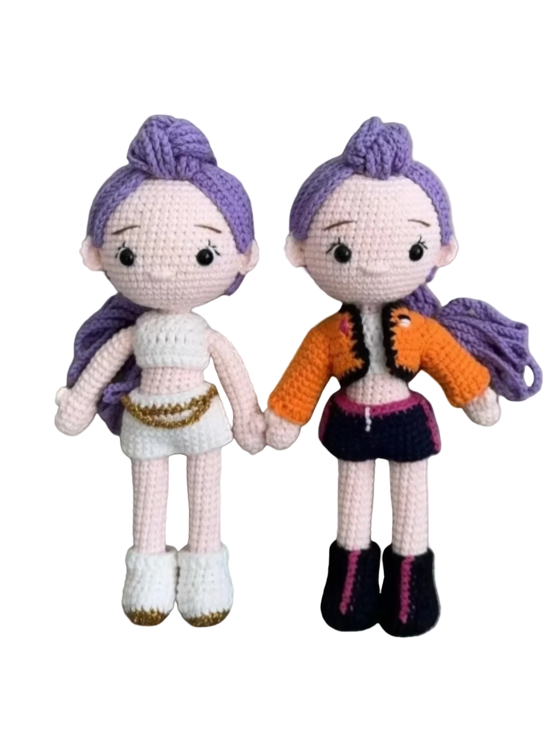 Suzie's Sunshine Dolls Rumi K-Pop Demon Hunter amigurumi doll with purple hair, one in white outfit, one in orange jacket and dark skirt.