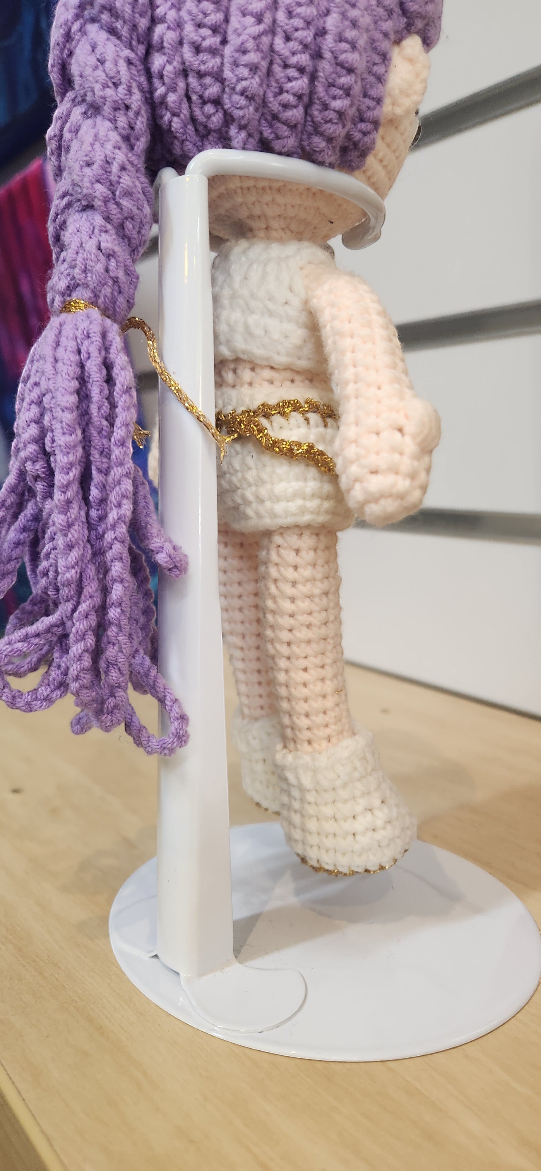 Suzie's Sunshine Dolls Rumi K-Pop Demon Hunter amigurumi doll with lilac hair and white outfit with gold trim.