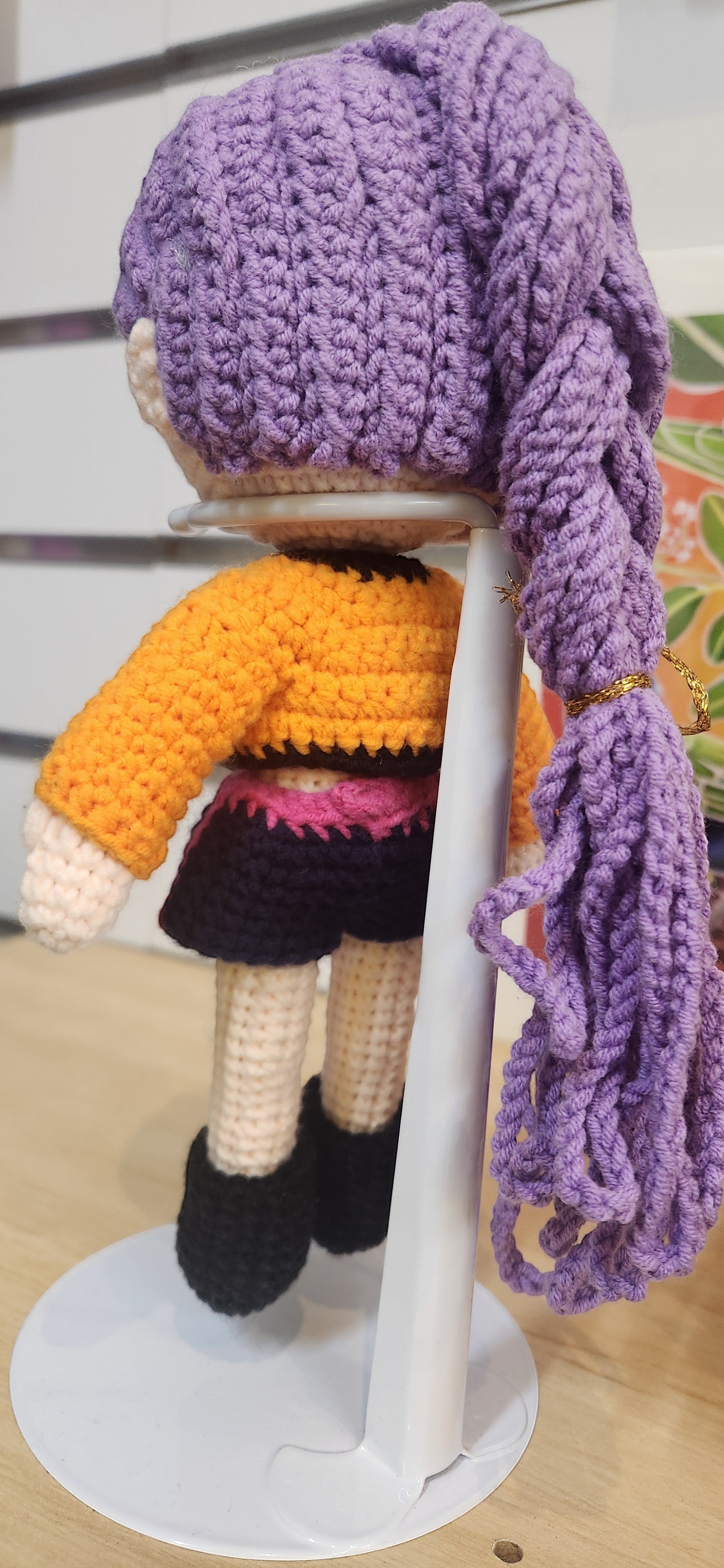 Suzie's Sunshine Dolls Rumi K-Pop Demon Hunter amigurumi doll with lilac hair, orange jacket, and black skirt.
