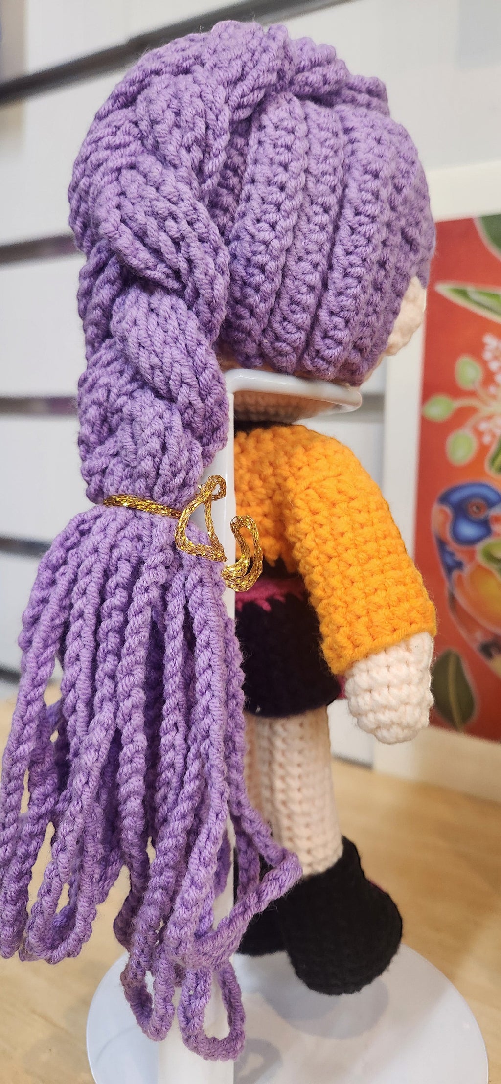 Suzie's Sunshine Dolls Rumi K-Pop Demon Hunter amigurumi doll with purple braided hair and orange jacket.