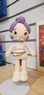 Suzie's Sunshine Dolls Rumi K-Pop Demon Hunter amigurumi doll with purple hair, white outfit, gold trim, and boots.