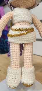 Suzie's Sunshine Dolls Rumi K-Pop Demon Hunter amigurumi doll in white outfit with gold trim and boots.