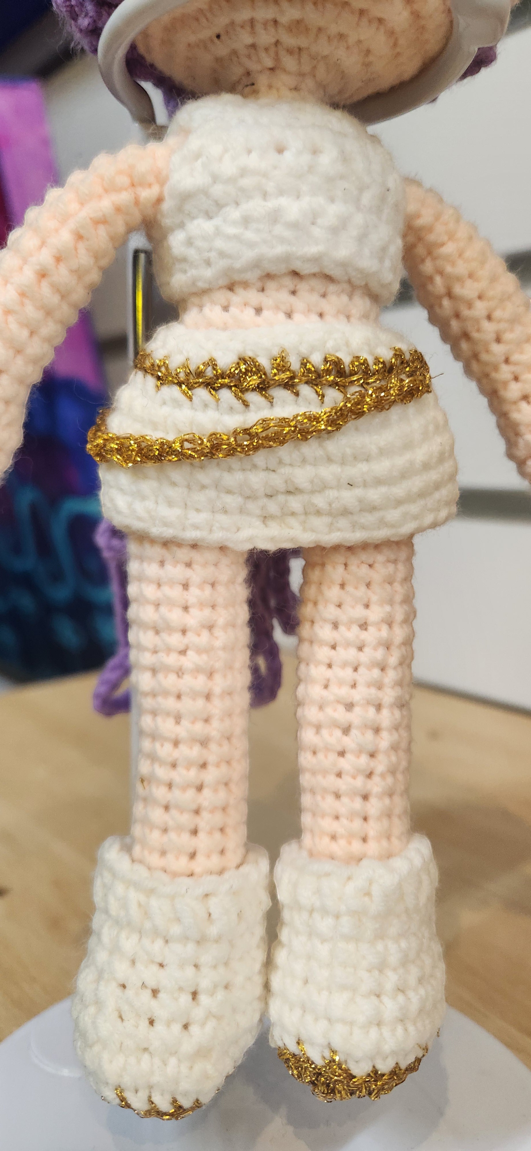 Suzie's Sunshine Dolls Rumi K-Pop Demon Hunter amigurumi doll in white outfit with gold trim and boots.