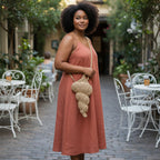 Suzie's Sunshine Dolls natural woven seashell shaped shoulder bag with braided strap.