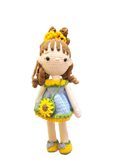 Suzie's Sunshine Dolls Sophie, a crocheted doll in a blue dress with yellow and green trim, sunflower purse, and flower crown.