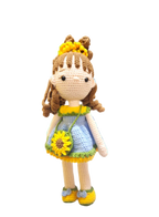 Suzie's Sunshine Dolls Sophie, a crocheted doll in a blue dress with yellow and green trim, sunflower purse, and flower crown.