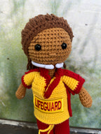 Suzie's Sunshine Dolls handmade crocheted surf lifesaver doll in red and yellow uniform with "LIFEGUARD" patch.