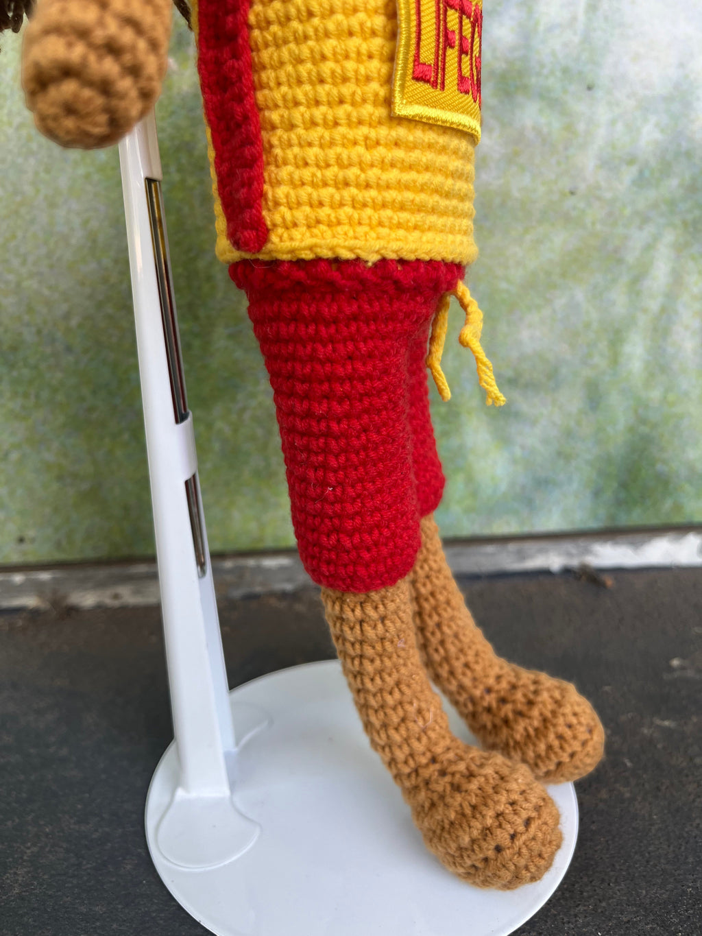 Suzie's Sunshine Dolls Surf Lifesaver doll in red shorts and yellow rashie with 'LIFE' patch. Crocheted, 28-30cm.