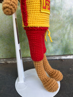 Suzie's Sunshine Dolls Surf Lifesaver doll in red shorts and yellow rashie with 'LIFE' patch. Crocheted, 28-30cm.