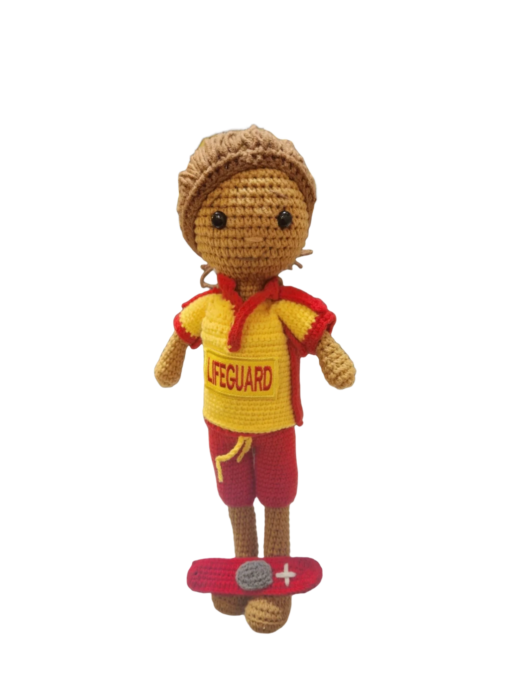 Suzie's Sunshine Dolls handmade crocheted surf lifesaver doll in red and yellow uniform with 'LIFEGUARD' text, standing on a red rescue float.