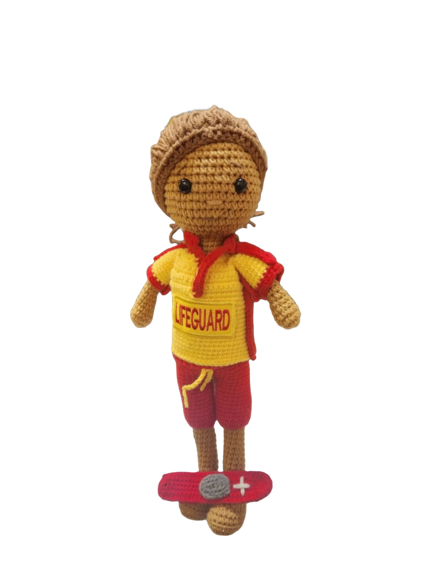 Suzie's Sunshine Dolls handmade crocheted surf lifesaver doll in red and yellow uniform with 'LIFEGUARD' text, standing on a red rescue float.