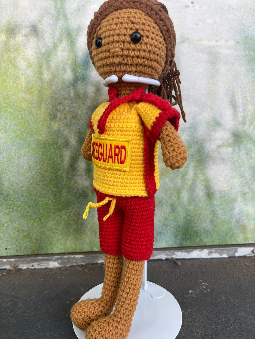 Suzie's Sunshine Dolls handmade crocheted surf lifesaver doll in red and yellow uniform with "LIFEGUARD" patch.