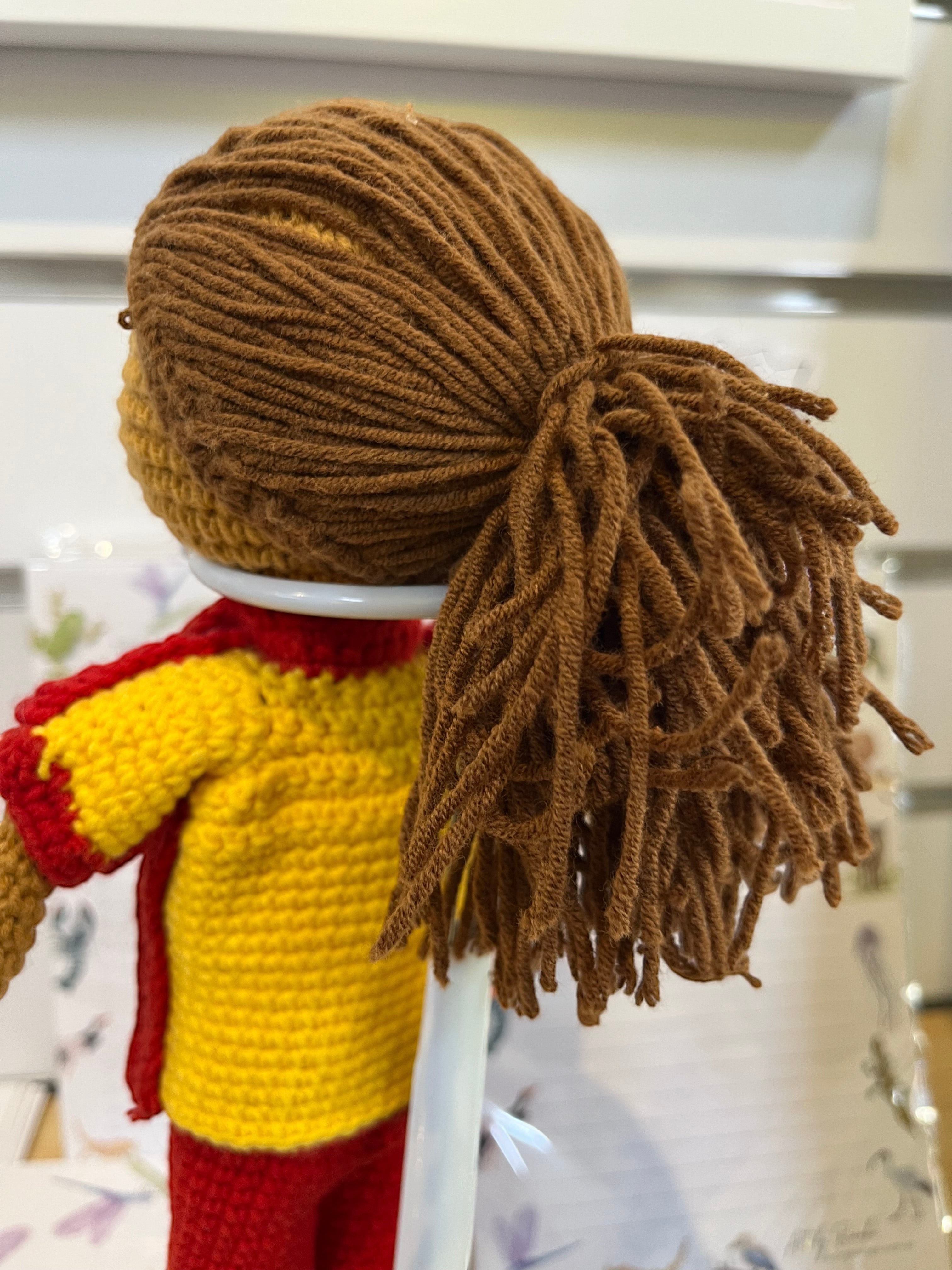 Suzie's Sunshine Dolls Surf Lifesaver doll, crocheted in red and yellow uniform with brown yarn hair.