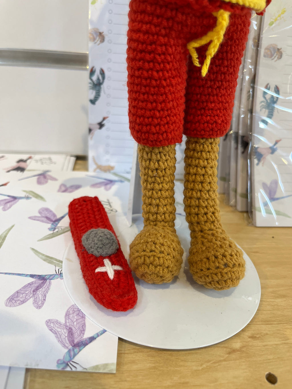 Suzie's Sunshine Dolls Surf Lifesaver doll in red shorts, yellow rashie, and tan legs, with a red rescue float accessory.