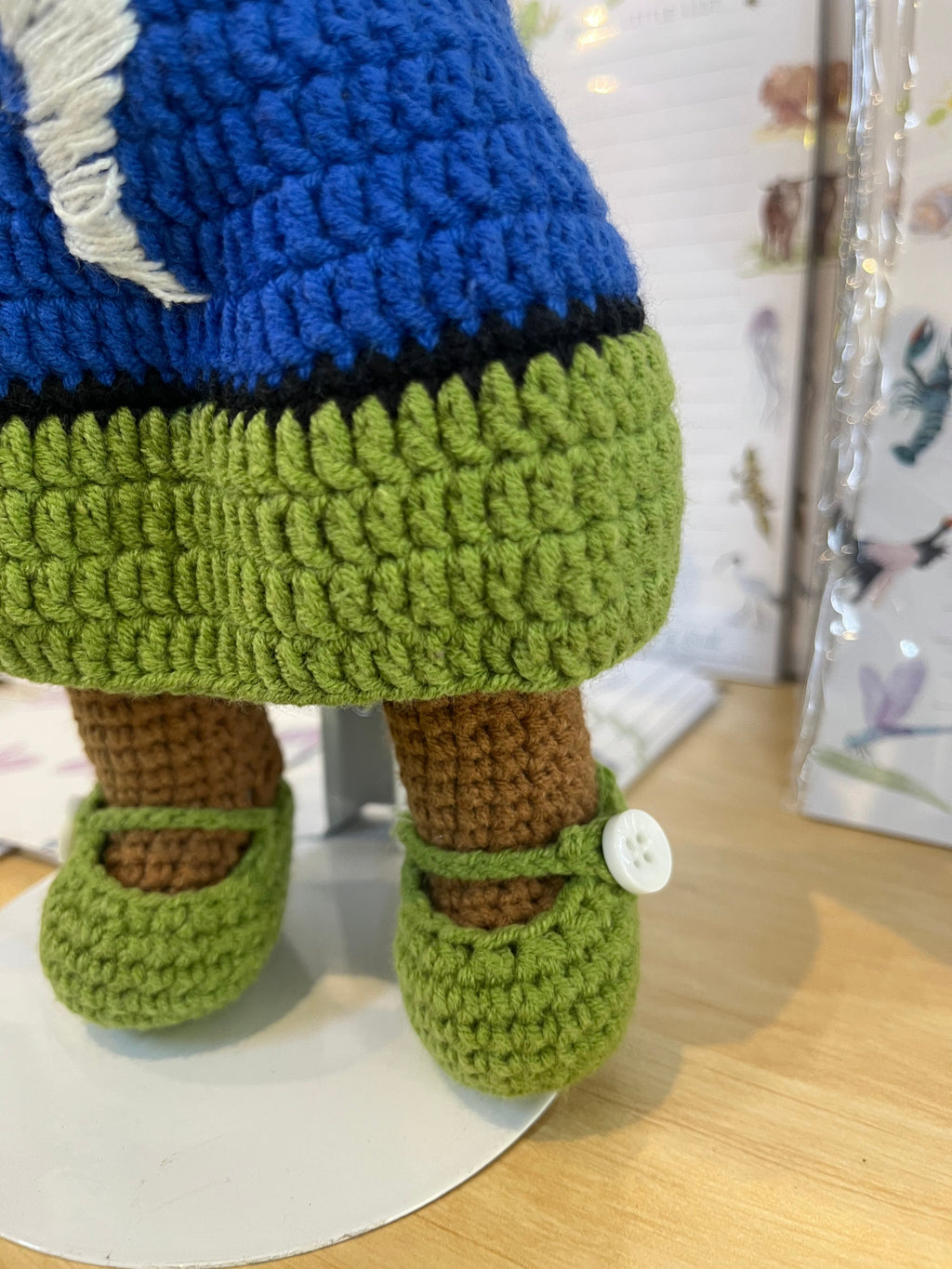 Suzie's Sunshine Dolls Torre Strait Islander doll with blue and green crocheted dress and white button shoes.