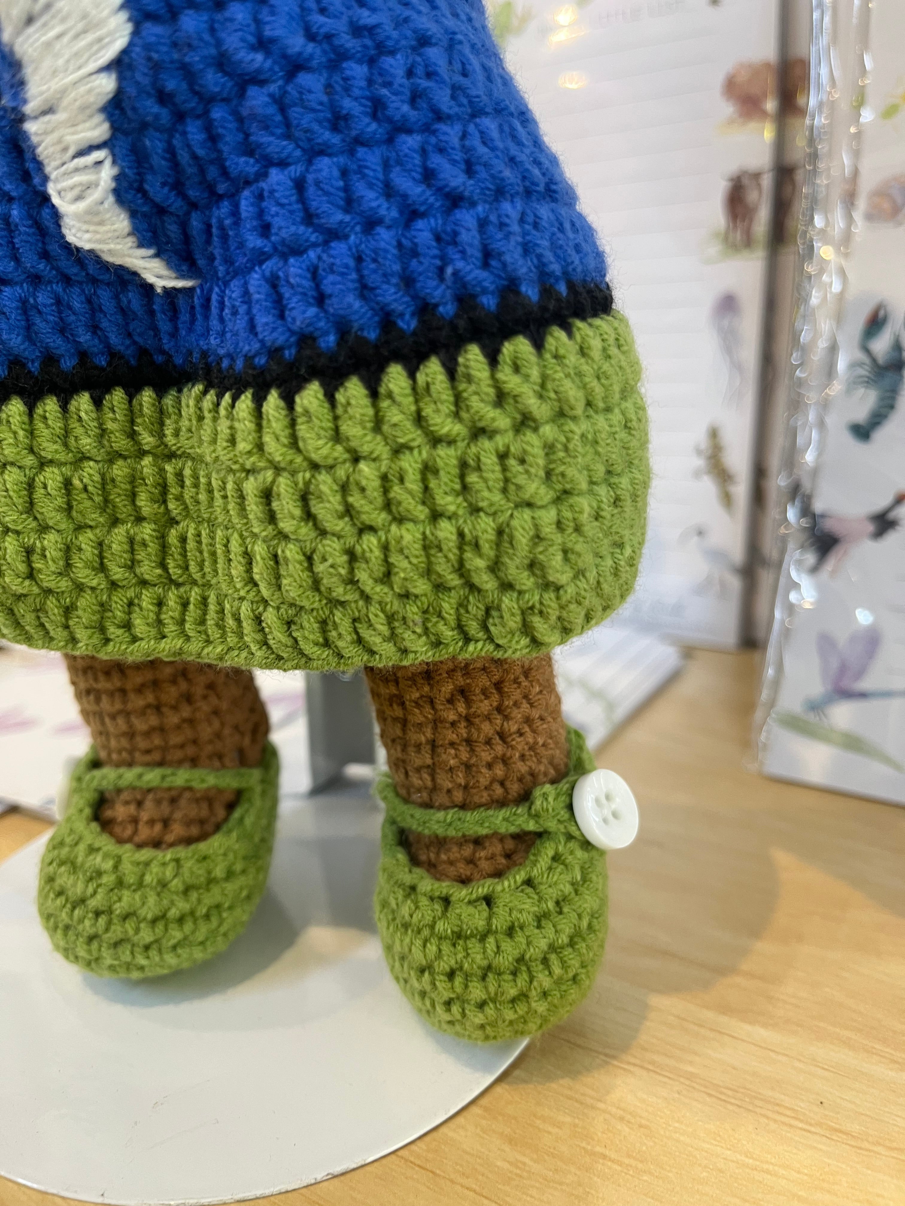 Suzie's Sunshine Dolls Torre Strait Islander doll with blue and green crocheted dress and white button shoes.