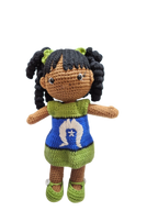 Suzie's Sunshine Dolls handmade crochet doll with long black curly hair, wearing a blue dress with Torres Strait Islander flag design and green trim.