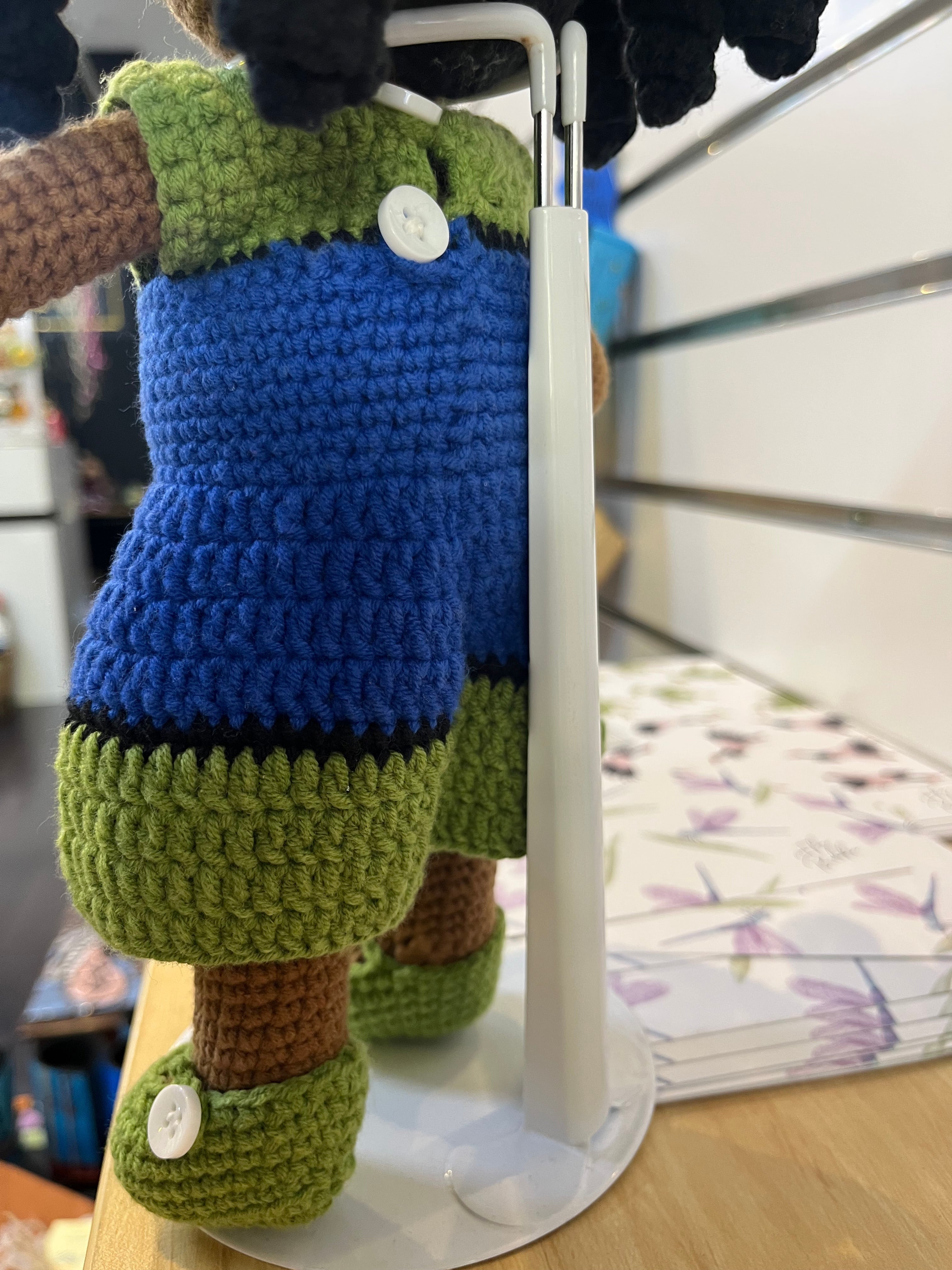 Suzie's Sunshine Dolls handmade Torres Strait Islander doll with long black hair, wearing a blue dress and green accents.