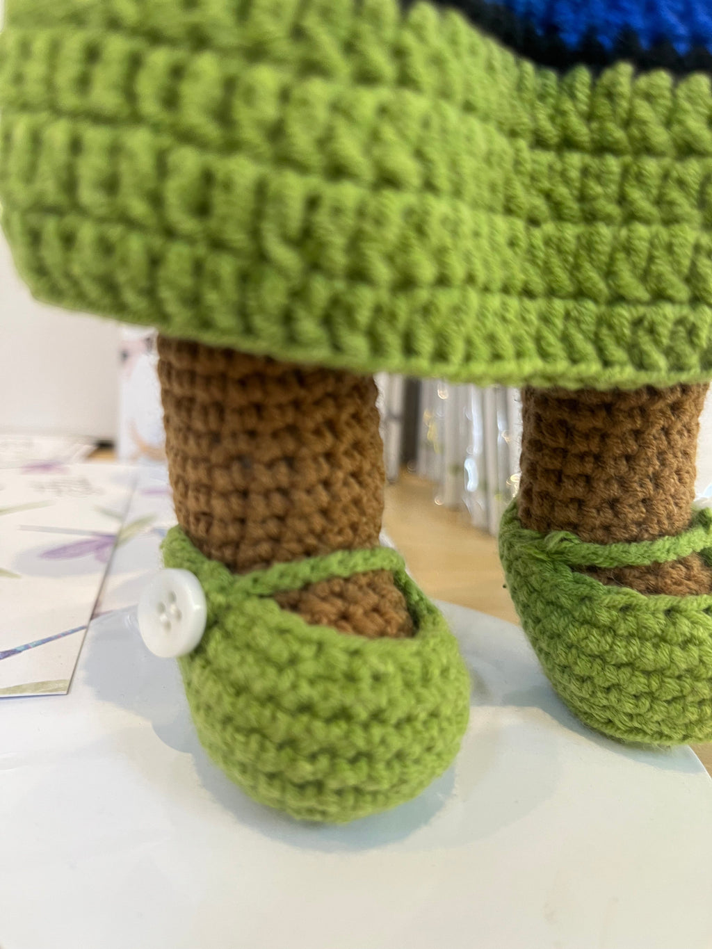 Suzie's Sunshine Dolls handmade Torres Strait Islander doll with green crochet shoes and brown legs.