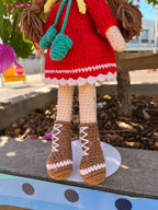 Suzie's Sunshine Dolls Zoey doll in red crochet dress, yellow beanie, turquoise scarf, and brown boots with white laces.