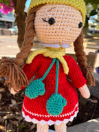 Suzie's Sunshine Dolls Zoey doll in red crocheted dress, yellow beanie, and turquoise scarf with mittens.